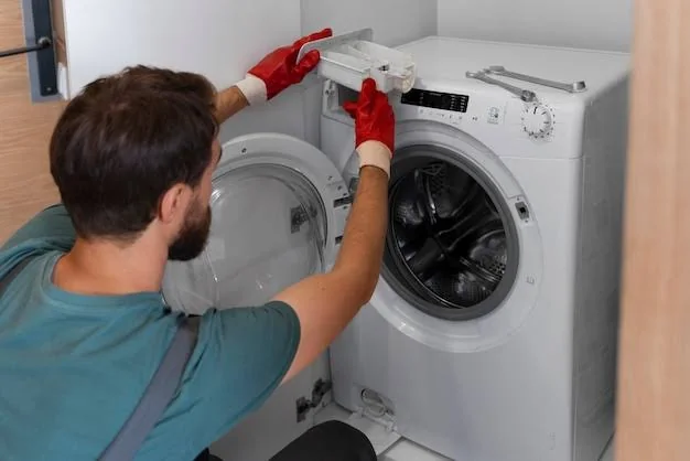 Technician inspecting a front-loading washing machine